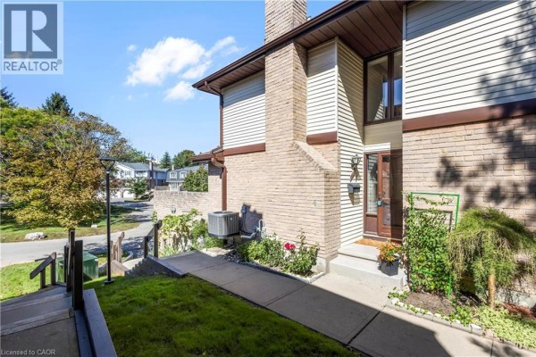 Walkway leading to the front door of a townhouse with brick and siding exterior. - 475 Beechwood Drive Unit# 4, Waterloo