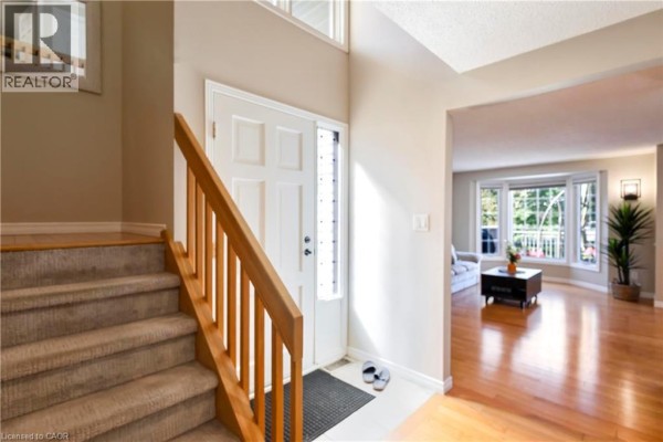 Interior view of the front entrance and staircase, with a doorway to the living area. - 475 Beechwood Drive Unit# 4, Waterloo