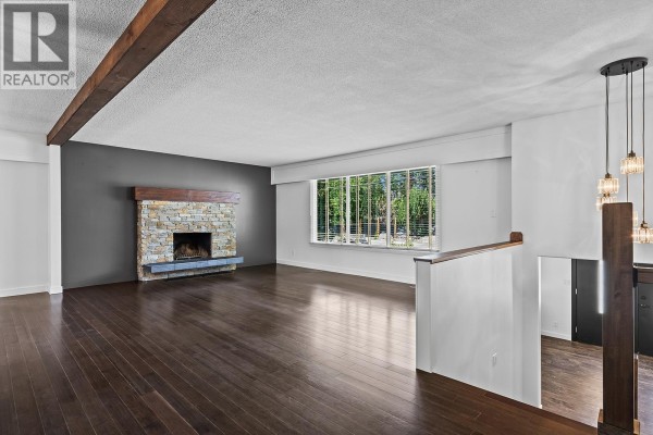 Welcoming foyer with wooden bench, mirror, and staircase leading to kitchen - 475 Collett Road, Kelowna