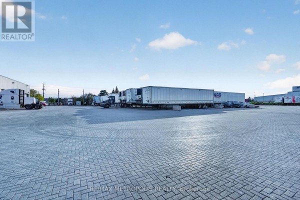 Aerial view of the property's cross-dock loading area with a truck and trailers. - 475 Harrop Drive, Milton