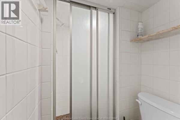 Modern bathroom with vanity, faucet, and graphic shower curtain - 475 Mckay Avenue Windsor