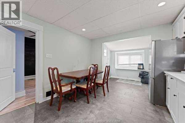 Bedroom with chalkboard wall, bed, and blue curtains - 475 Mckay Avenue Windsor