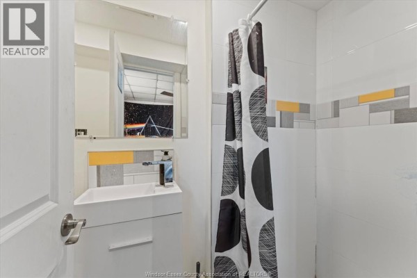 Basement with fireplace, hardwood floors, and paneled walls - 475 Mckay Avenue Windsor
