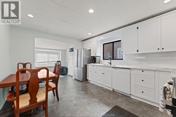Futon, fireplace, and mounted TV in basement - 475 Mckay Avenue Windsor