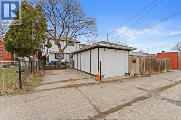 House with arched entryway and white brick facade - 475 Mckay Avenue Windsor