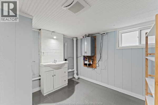 Bedroom with mattress, nightstand, wood floor & sloped ceiling - 475 Mckay Avenue Windsor