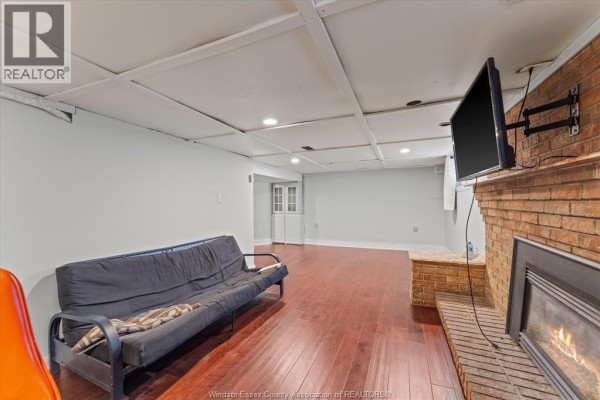 Covered front porch with white brick, seating, and archway - 475 Mckay Avenue Windsor