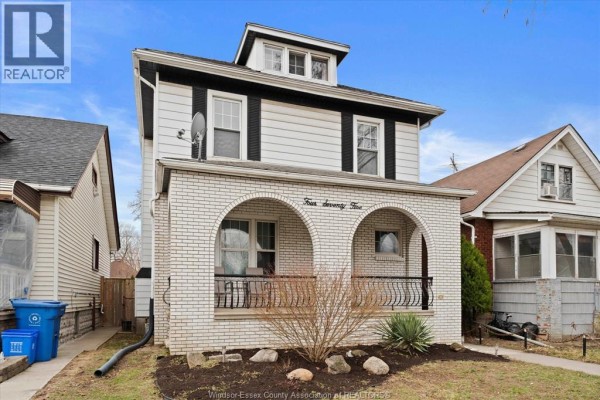 House with white brick arched entryways and dormer window - 475 Mckay Avenue Windsor