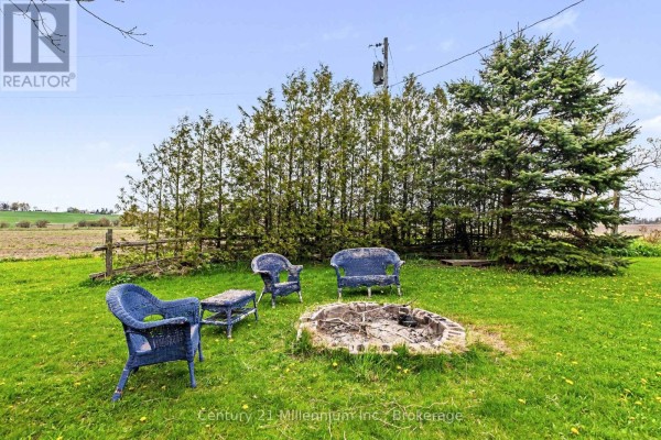Unfinished basement with stone walls, wooden stairs, and a small window. - 4758 Bruce 3 Road, Arran Elderslie