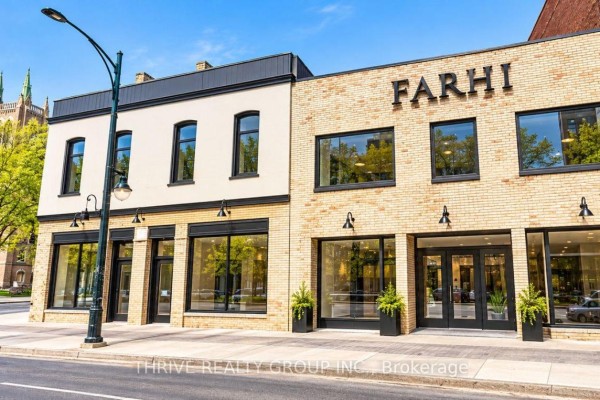 Storefronts with large windows and "FARHI" signage on a brick commercial building. - 478-484 Richmond Street, London East