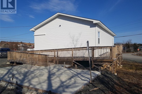 Exterior view of the building with a large wooden deck and staircase. - 478 Main Street, Whitbourne