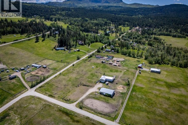 Aerial view of a rural community with scattered houses, farm buildings, and fenced pastures. - 4780 Harrison Road, Pritchard