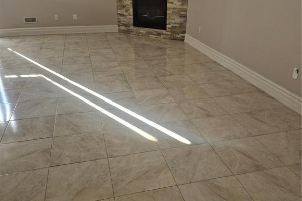 Another view of the living room floor with beige tiles and sunlight casting shadows. - 4783 Periwinkle Unit# Lower, Windsor