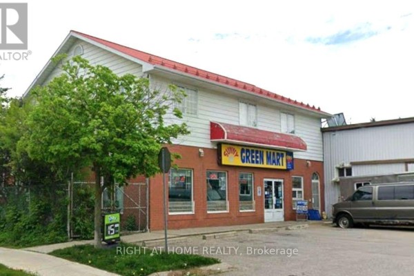 Front view of Sunny Green Mart building with brick lower level and white upper level. - 47a Town Line, Orangeville