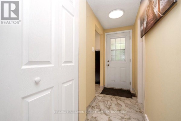 Interior hallway with a white door and a large closet. - 48 - 1005 Cloister Gardens, Ottawa
