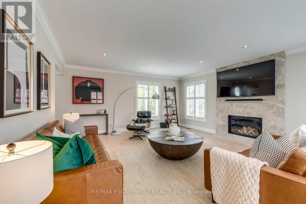 Interior foyer with a high ceiling, large windows, and a white front door. - 48 Forsythe Street, Oakville