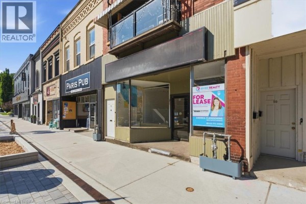 Street view of commercial building with adjacent 'Paris Pub' and display windows. - 48 Grand River Street N, Paris