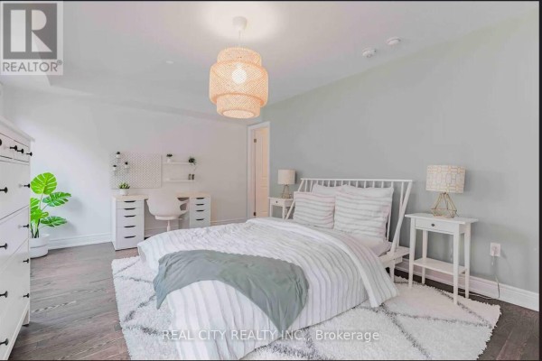 Bright bedroom with a white bed, white dresser, white desk, and light grey walls. - 48 Hiawatha Court, Vaughan
