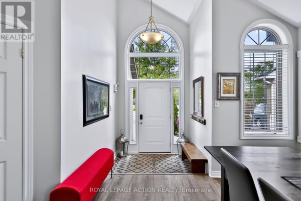 Bright entryway with a white door, large arched window, and a red bench. - 48 Holkham Avenue, Hamilton