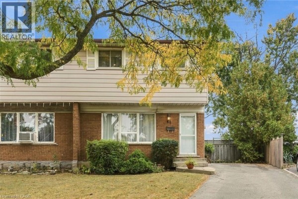 Front exterior of a semi-detached house with brick lower level and siding upper level. - 48 Raleigh Court, Hamilton