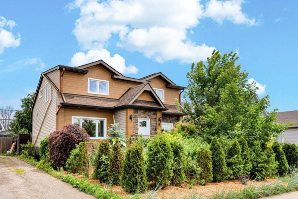 Side exterior view of house with wooden gate and deck with outdoor seating. - 48 Rue St-josaphat, Gatineau