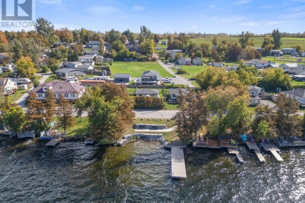 Aerial view of houses on a lakefront street with docks and boats. - 48 Sliverbirch Street, Kawartha Lakes