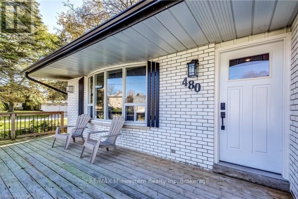 Front door entrance of white brick house with large window on porch. - 480 Cavan Street, Minto