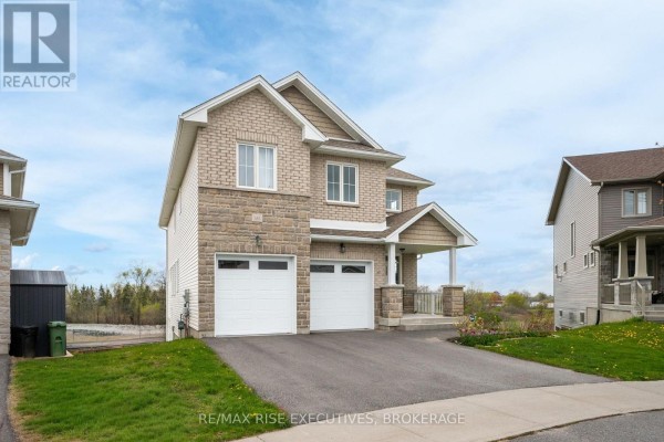 Laundry room featuring stacked LG washer and dryer, beige walls, and a window. - 483 Beth Crescent, Kingston