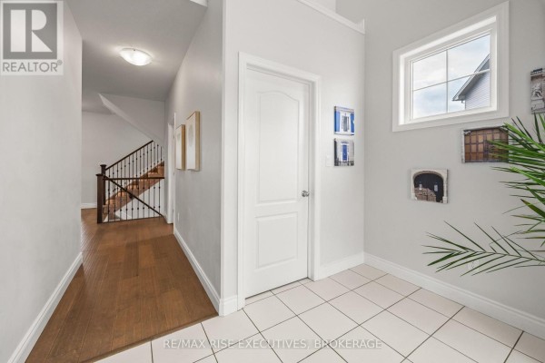 Kitchen with white cabinetry, stainless steel appliances, and quartz countertops. - 483 Beth Crescent, Kingston