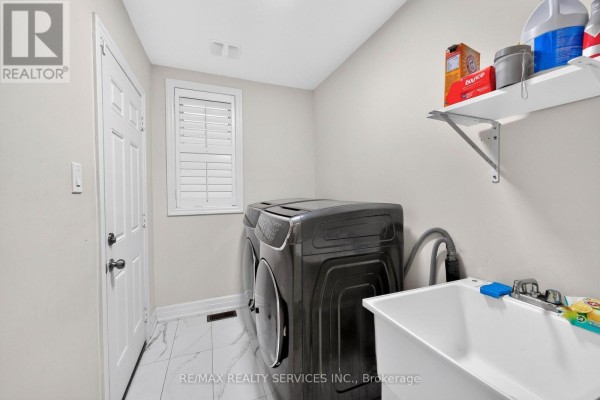 Stackable washer and dryer with utility sink and shelving - 484 Greenwood Drive Essa