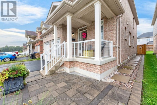 Front porch of a brick house with stone pavers leading to the entrance and stairs. - 484 Greenwood Drive, Essa