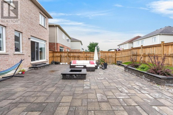 Backyard with paver patio, fire pit, and seating - 484 Greenwood Drive Essa