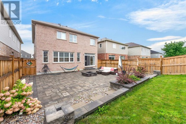 Brick house backyard with paver patio, fire pit, sofa set, hammock - 484 Greenwood Drive Essa