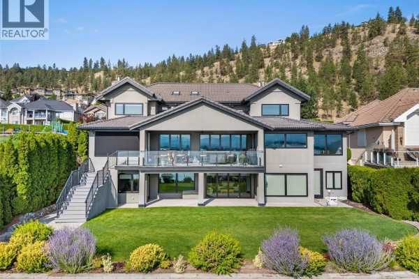 Aerial view of homes along the waterfront, with sandy beach and dock visible. - 485 Casa Rio Drive, West Kelowna