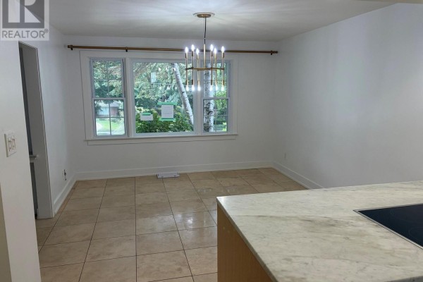 Dining area with tile floor, large windows, and modern chandelier. - 485 Regent Street, London East
