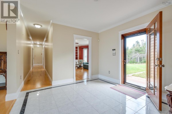 Bedroom with two queen beds, light wood floors, and a window. - 485&489 Maple Drive, Cape George