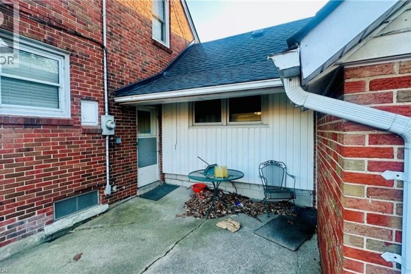 Room with fireplace, storage items, and cluttered layout - 486 Matthew Brady Avenue, Windsor