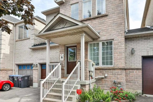 Front exterior of a light brick detached home with a covered porch, stairs, and garden beds. - 4882 Vienna Court, Mississauga