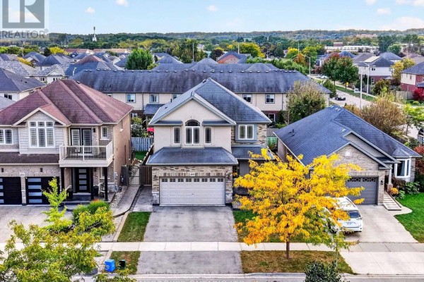 Aerial view of 4890 Allan Court, a two-story house with garages and surrounding residential homes. - 4890 Allan Court, Lincoln