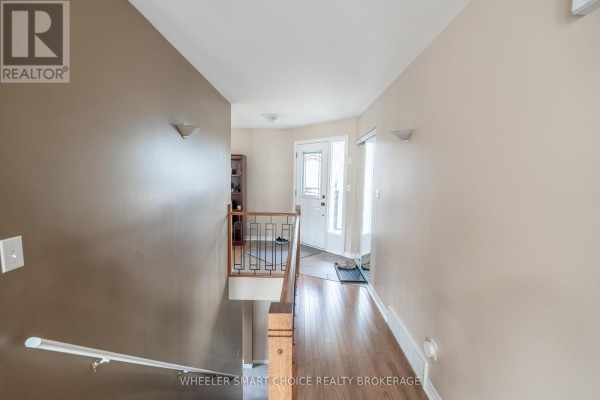 Hallway with hardwood floors, entryway, and staircase - 49 Barnhart Drive South Stormont