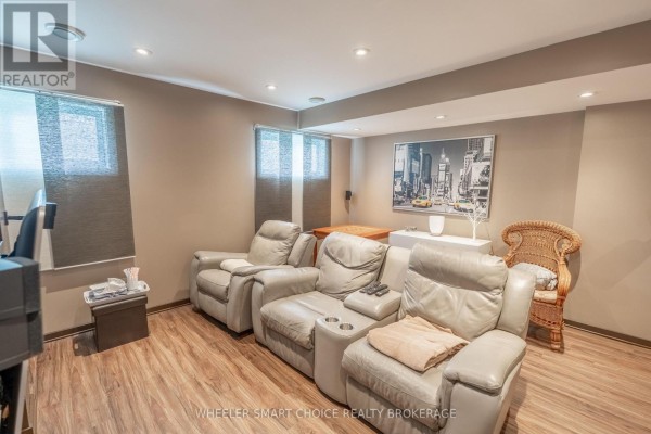 Reclining sofas and wicker chair in finished basement - 49 Barnhart Drive South Stormont