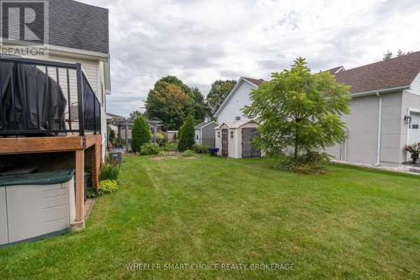 Backyard with deck, sheds, tree, lawn - 49 Barnhart Drive South Stormont