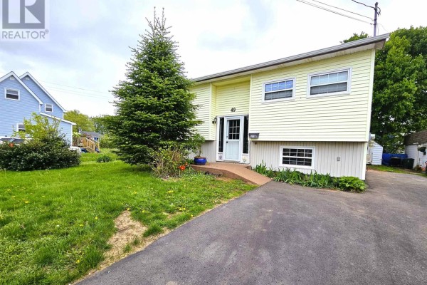 Room with bright green walls, light wood-look flooring, baseboard heating, and a window. - 49 Hill Street, Amherst