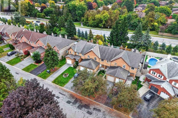 Aerial view of a street with multiple brick townhouses and detached homes. - 49 Robarts Crescent, Ottawa