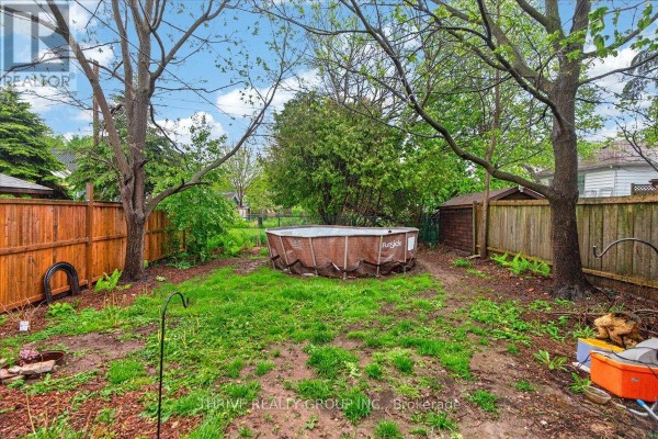 Yard with above-ground pool, shed, and wooden fence - 494 Highbury Avenue N London East