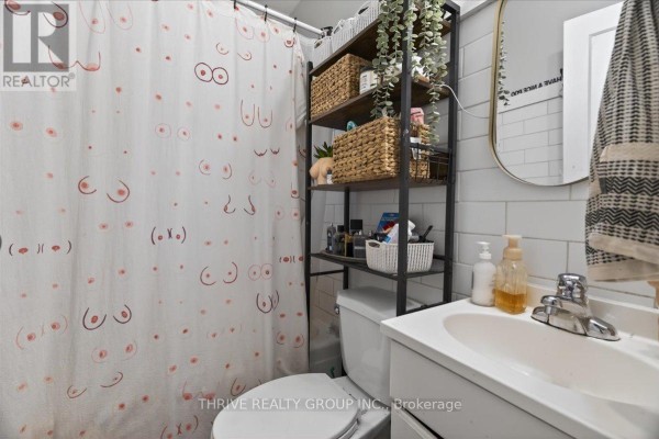 Bathroom with novelty shower curtain and white subway tiles - 494 Highbury Avenue N London East