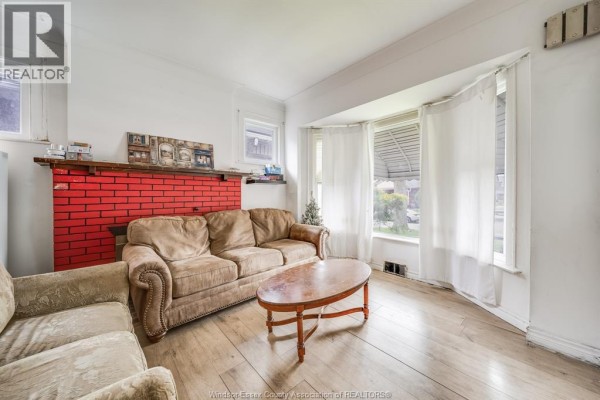 A small room with a metal bed frame and mattress on tiled flooring. - 494 Rankin, Windsor