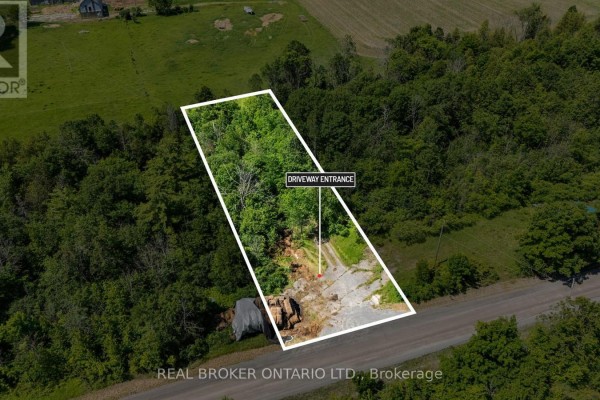 Aerial view of the driveway entrance and part of the wooded property at 4983 Stonecrest Road. - 4983 Stonecrest Road, Ottawa