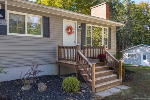 Close-up of the front steps leading to the white front door and windows of the bungalow. - 499 Ledge Road, Dufferin