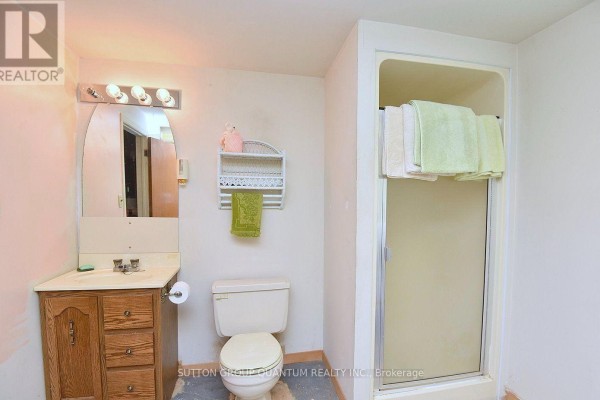 Bathroom with vanity, arched mirror, toilet, and shower stall - 499 Valley Drive N Oakville